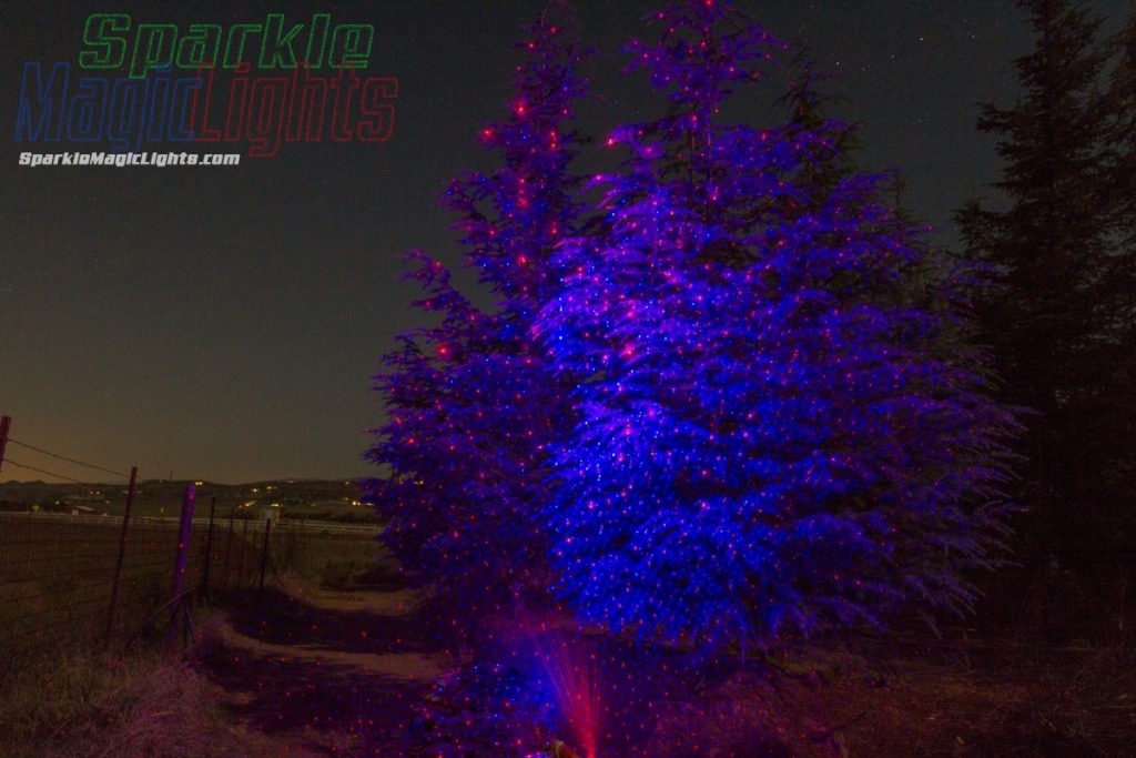 Pretty Pretty Blue laser light on trees, with a touch of red...